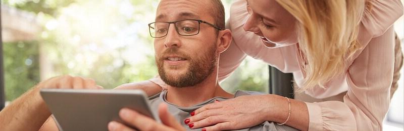 couple reading a tablet